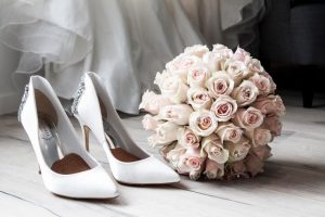 White wedding shoes with bouquet